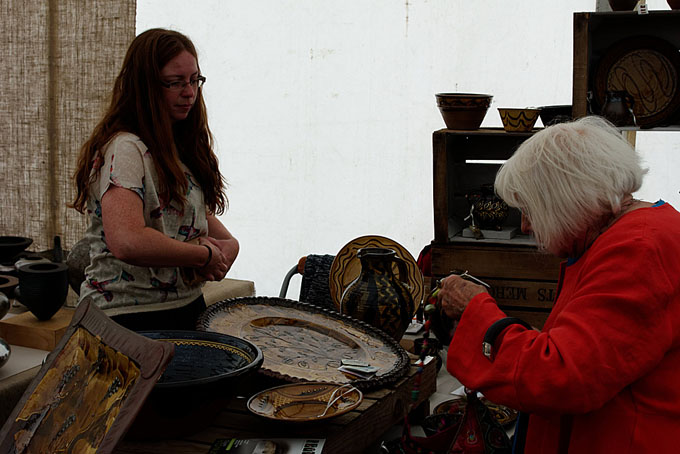 Art in Clay 2014 Hatfield - Hannah McAndrew selling a pot to Mary Wandrauch