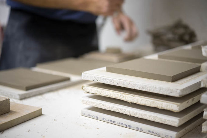 Tile making at Douglas Watson Studios - Dr Pete Spring hand cutting the tile blanks