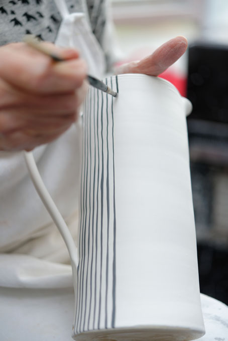 Sue Binns decorating in her studio in London 2013 - Cobalt is applied over a matt glaze.