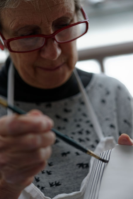 Sue Binns decorating in her studio in London 2013 - Cobalt is applied over a matt glaze.
